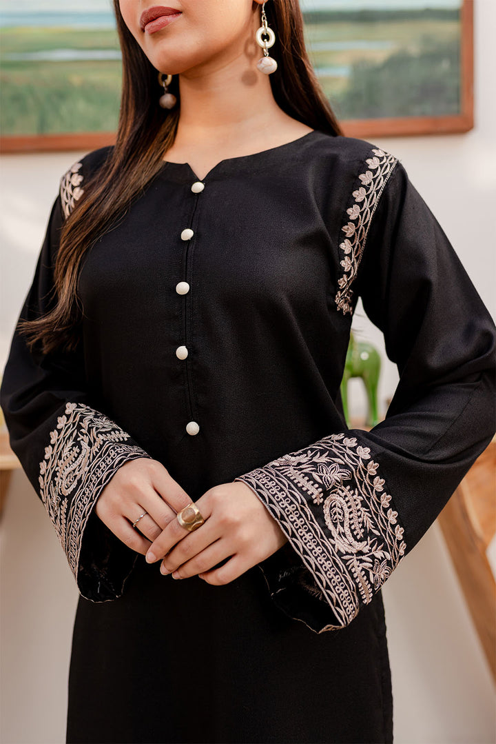 Women's black cotton two-piece fashion set with embroidered sleeves and decorative buttons.